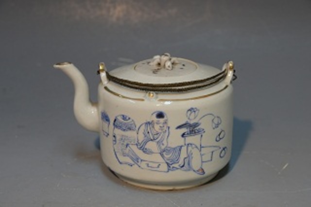 The boy aspires to the blue color teapot